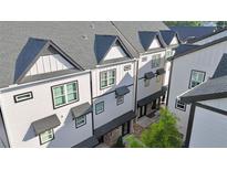 Charming townhomes with modern architectural details and dark rooflines create a cohesive and appealing street view at 2587 Ocean Walk Nw Dr, Atlanta, GA 30318