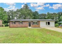 Charming brick home with well-manicured lawn and updated landscaping at 3799 Sweetbriar Cir, Lithia Springs, GA 30122