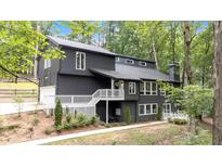 Charming two-story home featuring a spacious deck, modern siding, and lush greenery at 510 Watergate Ct, Roswell, GA 30076