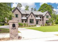 Stunning brick home with well-manicured lawn, brick mailbox and elegant driveway at 3338 Breton Ne Cir, Brookhaven, GA 30319