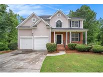 Charming two-story home with a well-manicured lawn and a two-car garage at 2681 Lakeside Sw Dr, Conyers, GA 30094
