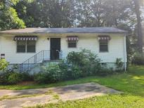 Modest single story home with white siding and red and white awnings at 449 Hamilton E Holmes Nw Dr, Atlanta, GA 30318