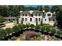 Stunning Mediterranean-style home boasts meticulous landscaping and a grand facade with arched windows at 4309 Sentinel Post Nw Rd, Atlanta, GA 30327