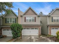 Charming two-story townhome with attached two-car garage and brick accents in desirable neighborhood at 1684 Tailmore Ln, Lawrenceville, GA 30043