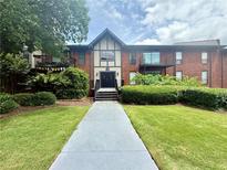 Charming brick condo building with well-maintained landscaping and inviting entrance at 6851 Roswell Rd # D33, Atlanta, GA 30328