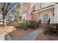 Charming townhome with brick accents, neat landscaping, and welcoming front entrance at 220 Riverview Trl, Roswell, GA 30075
