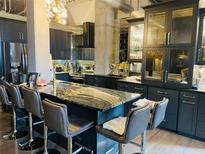 Modern kitchen featuring a large island with a striking countertop and bar stool seating at 3180 Mathieson Drive # 502, Atlanta, GA 30305