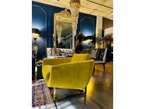 A stylish living room features a yellow velvet chair, decorative mirror, and dark paneled walls at 3180 Mathieson Drive # 502, Atlanta, GA 30305