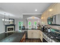 An open kitchen with stainless steel appliances, granite countertops, and dark hardwood floors at 1786 Dekalb Ne Ave, Atlanta, GA 30307