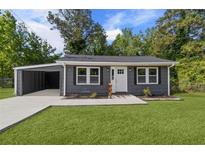 Charming gray home with a well-manicured lawn and a convenient carport at 389 Oglesby Bridge Se Rd, Conyers, GA 30094