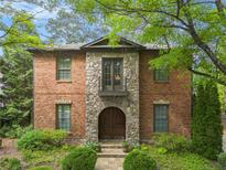 Charming brick home featuring a stone facade, arched doorway and second story balcony at 612 Concord Lake Se Cir, Smyrna, GA 30082