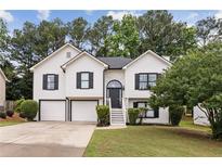 Charming two-story home features a manicured lawn and attached two-car garage, enhancing curb appeal at 4733 Julian Way, Acworth, GA 30101