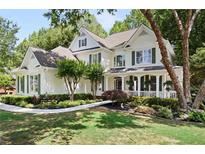 Charming two-story home boasts a beautifully landscaped front yard with mature trees and inviting front porch at 5258 Tallgrass Nw Way, Kennesaw, GA 30152
