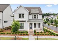 Charming two-story home with a welcoming front porch and beautifully landscaped front yard at 993 Harvest Park Ln, Suwanee, GA 30024
