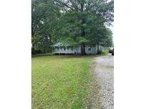 Quaint single-story home featuring a welcoming front porch and surrounded by mature trees and a spacious yard at 36 Mount Tabor Rd, Covington, GA 30014