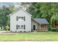 Charming two-story home features a well-manicured lawn and inviting stone accents at 1111 Fieldgate Rd, Lawrenceville, GA 30044