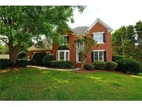 Charming two-story brick home with lush landscaping and a well-maintained front yard at 1601 Haven Crest Ct, Powder Springs, GA 30127