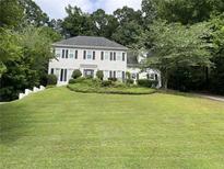 Charming two-story home featuring a manicured lawn, neutral paint, and dark shutters at 640 Belgrave Ln, Tucker, GA 30084