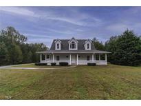 Charming home featuring a large front porch, dormer windows, and a well-maintained lawn at 385 Eagles Nest Cir, Carrollton, GA 30116