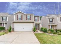 Charming two-story home featuring a manicured lawn, a two-car garage, and tasteful landscaping at 2385 Mayfair Dr, Cumming, GA 30040