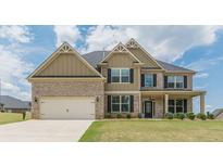 Charming two-story home with a brick and siding exterior and a well-manicured lawn at 171 Osier Dr, Mcdonough, GA 30252