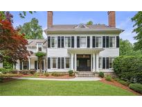 Stately two-story home featuring a manicured front yard, black shutters, and classic architectural details at 4356 N Buckhead Ne Dr, Atlanta, GA 30342