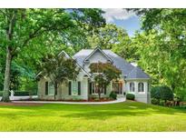 Charming traditional home with lush landscaping and a well-manicured lawn at 10635 N Edgewater, Johns Creek, GA 30097