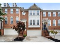 Charming brick townhouse with a two-car garage and beautifully landscaped front yard at 4855 Payson Se Ter # 3, Atlanta, GA 30339