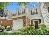 Charming home featuring stone accents, a two-car garage, and well-maintained landscaping at 129 Finsbury Ln, Woodstock, GA 30188