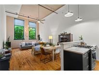 Bright living room boasts an open layout, high ceilings, and large windows providing ample natural light at 19 Hilliard Se St # 13, Atlanta, GA 30312
