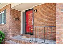 Inviting front porch featuring brick accents, a red door and black trim, providing a warm welcome to the residence at 3322 Northcrest Rd # A, Atlanta, GA 30340