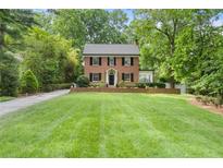 Charming two-story brick home with mature trees and a well-manicured lawn provides great curb appeal at 905 Stovall Ne Blvd, Atlanta, GA 30319