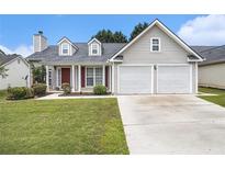 Charming single-Gathering home featuring a well-manicured lawn and a two-car garage at 7008 Glen Valley Way, Fairburn, GA 30213
