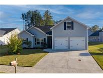 Charming home with a two-car garage, well-maintained lawn, and lovely curb appeal at 504 Cole Creek Dr, Dallas, GA 30157