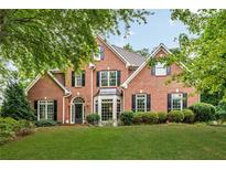Stunning brick home with manicured lawn and mature trees exudes curb appeal at 4020 Devereux Chase, Roswell, GA 30075