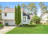 Charming two-story home with a well-manicured lawn and a welcoming front porch at 2325 E Hill Way, Norcross, GA 30071