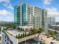 Modern high-rise building with glass facade and balconies, showcasing urban living and architecture at 250 Pharr Ne Rd # 1814, Atlanta, GA 30305