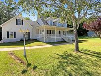 Charming two-story home featuring a large porch, well-manicured lawn, and beautiful curb appeal at 132 Lynnview Ct, Mcdonough, GA 30252