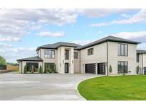 Stunning white brick home featuring a spacious driveway and lush green lawn at 2751 Camp Branch Rd, Buford, GA 30519