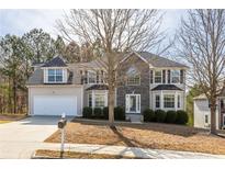 Charming two-story home featuring a stone facade and a well-manicured front lawn at 3448 Craggy Perch, Douglasville, GA 30135