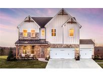 Charming two-story home showcasing a blend of board and batten siding and brick, creating a modern farmhouse aesthetic at 4720 Montane St, Cumming, GA 30028