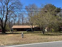 Quaint one-story brick home with mature trees and a fire hydrant in the front yard at 5317 Kings Hwy, Douglasville, GA 30135