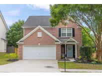 Charming brick two-story home with well-manicured lawn, attached garage and inviting entryway at 1186 Hawthorn Ln, Grayson, GA 30017
