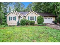 Charming home featuring a two-car garage and lush green lawn at 273 Apalachee Church Rd, Auburn, GA 30011