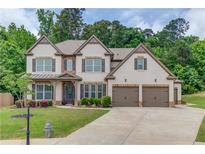 Charming two-story home boasts manicured landscaping, three-car garage and beautiful brick and siding exterior at 4241 Summer Breeze Way, Buford, GA 30518