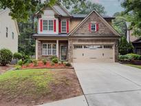 Charming two-story brick home featuring a two-car garage and well-maintained landscaping at 750 Summerstone Ln, Lawrenceville, GA 30044