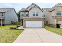 Charming two-story home featuring a brick-accented garage and well-maintained front lawn at 2317 Church Street, Hampton, GA 30228