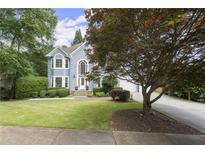Charming two-story home with a well-manicured lawn and beautiful landscaping at 3260 Kingshouse Commons, Johns Creek, GA 30022