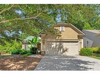 Charming single-Gathering home boasts a lush front yard and a two-car garage, complemented by mature trees and landscaping at 4535 Vanadium Bnd, Cumming, GA 30040