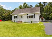 Charming home with a well-maintained lawn and classic architecture, blending comfort with curb appeal at 8185 Rivertown Rd, Fairburn, GA 30213